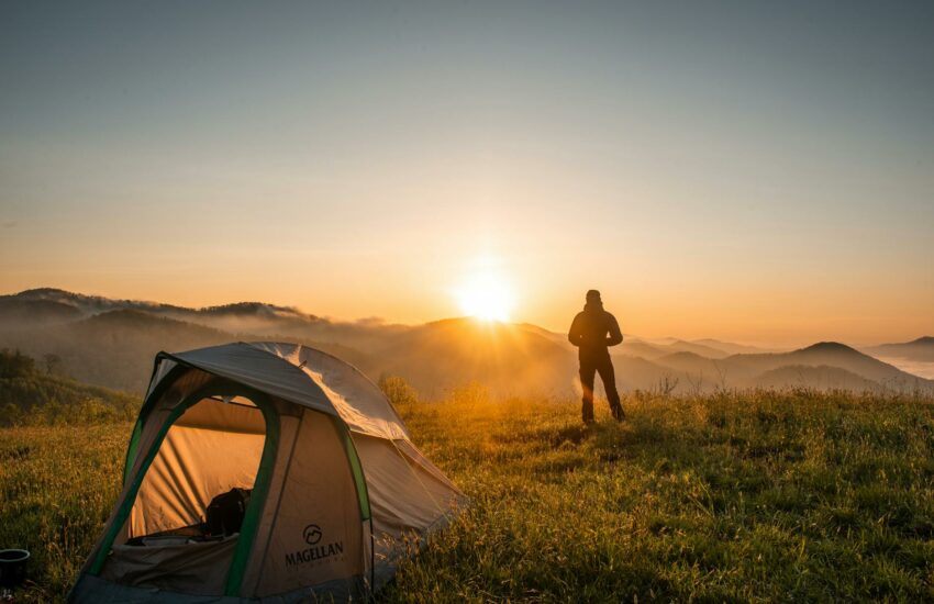 silhouette of person standing near camping tent